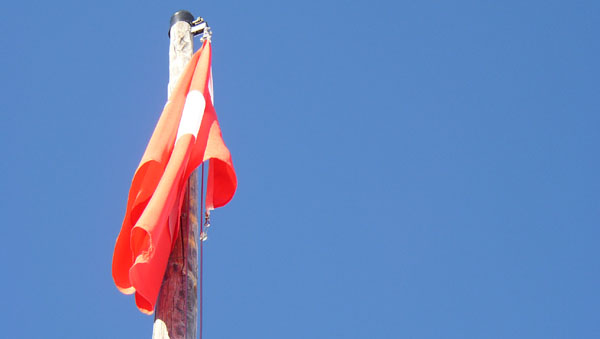 Swiss flag  against a blue sky